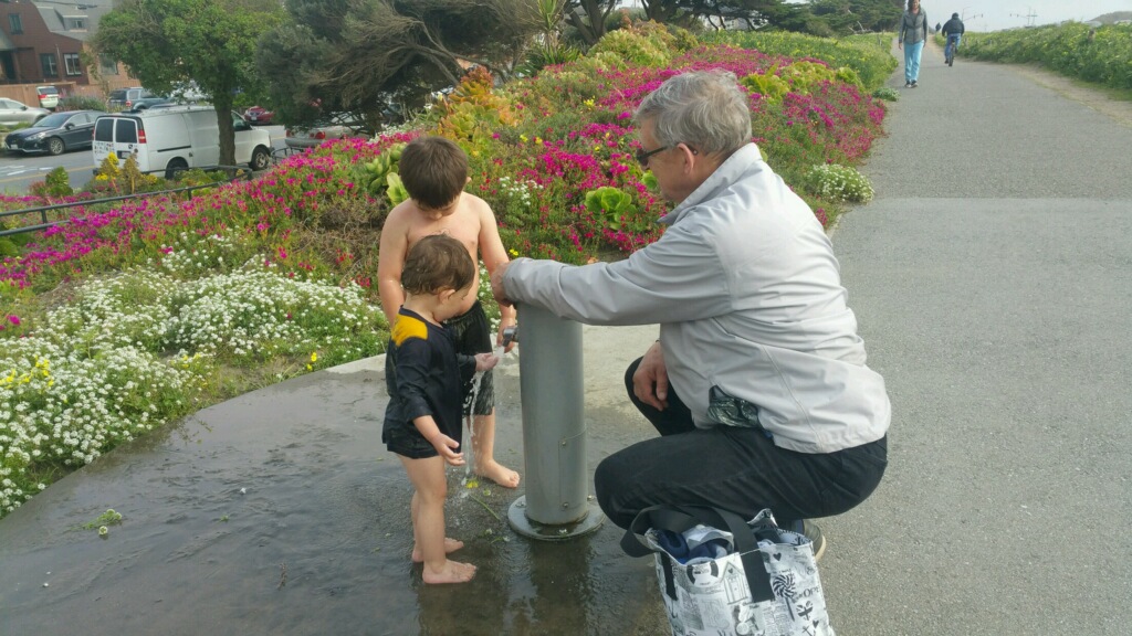 Cleaning off with Grandpa at Ocean Beach